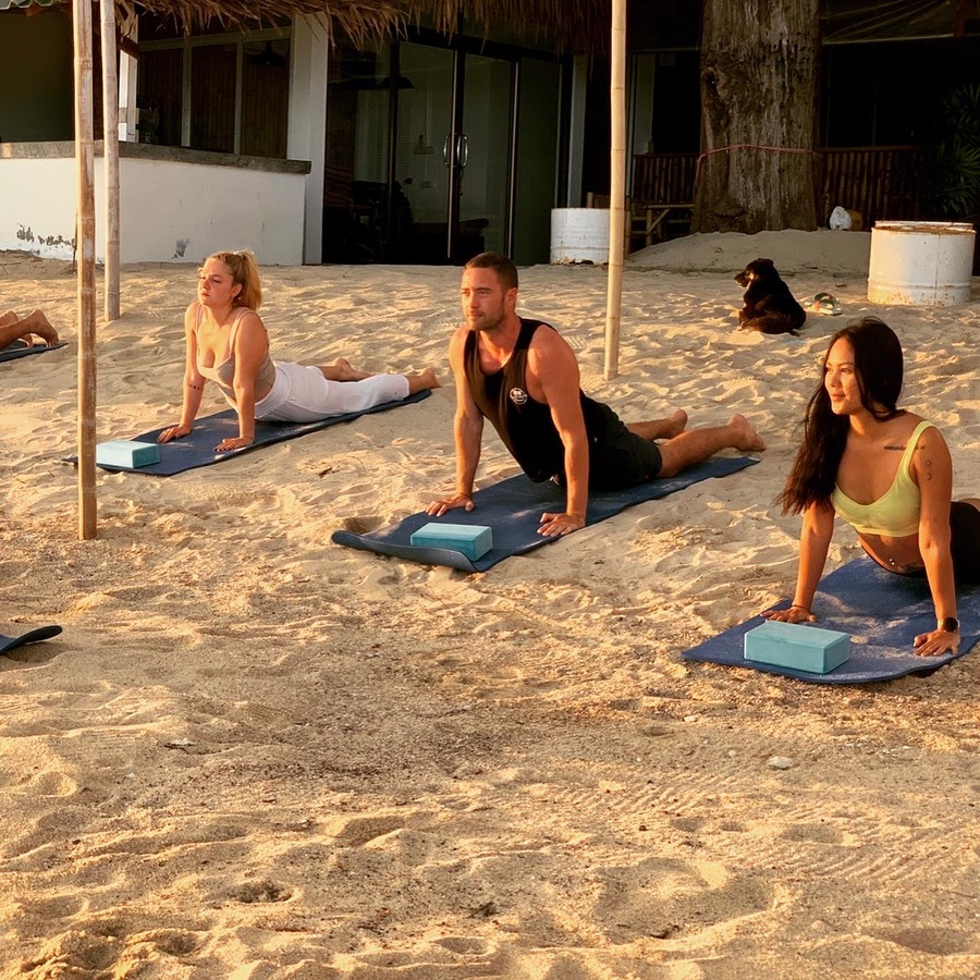 A group yoga session on the beach
